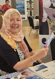 lady looking at a lealfet